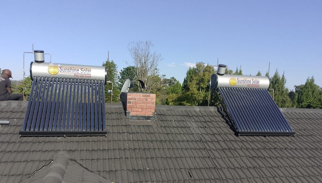 Two Sunshine Solar evacuated-tube geysers installed on a tiled roof in Harare
